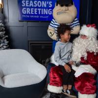 Boy looks at Santa sitting on his lap